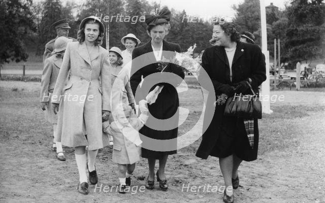 Crown Prince Carl Gustav with mother Sibylla and big sister Margaretha, Stockholm, 1947.  Creator: Unknown.
