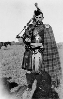 Unknown man in full Scottish kilt with bagpipes, c1900s. Creator: Robert Augustus Henry L'Estrange.