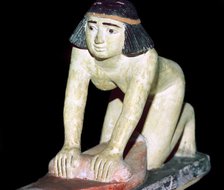 Painted figure of an Egyptian servant making bread. Artist: Unknown