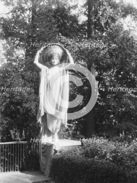 Person wearing a mask made by W.T. Benda, 1925 Sept. 20. Creator: Arnold Genthe.