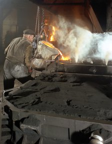 Pouring molten metal from a cupola into moulds, steel bath production, Hull, Humberside, 1965. Artist: Michael Walters