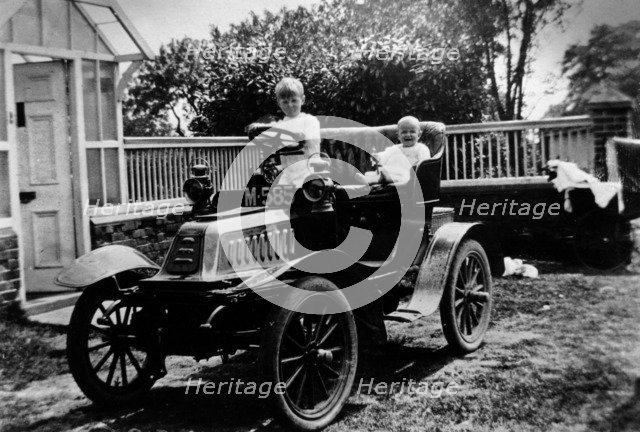 A child at the wheel of a De Dion Bouton car, 1903. Artist: Unknown