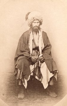 Full-length portrait of man, seated, facing front, between 1870 and 1886. Creator: Unknown.