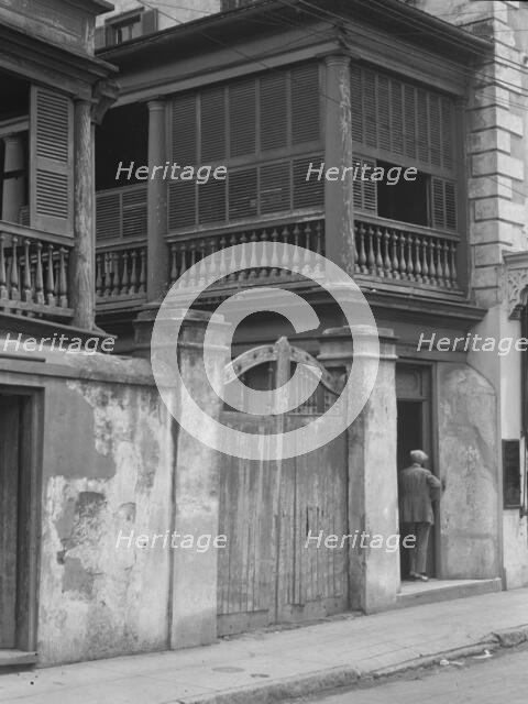 Multi-story house behind gated wall, New Orleans or Charleston, South Carolina, c1920-1926. Creator: Arnold Genthe.