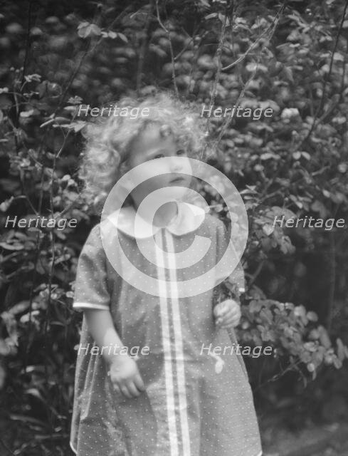 McCormick, Medill, child of, standing outdoors, 1923 May 21. Creator: Arnold Genthe.