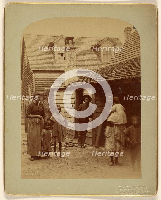 Portrait of a Black family standing in front of a house, 1886. Creator: George Barker.