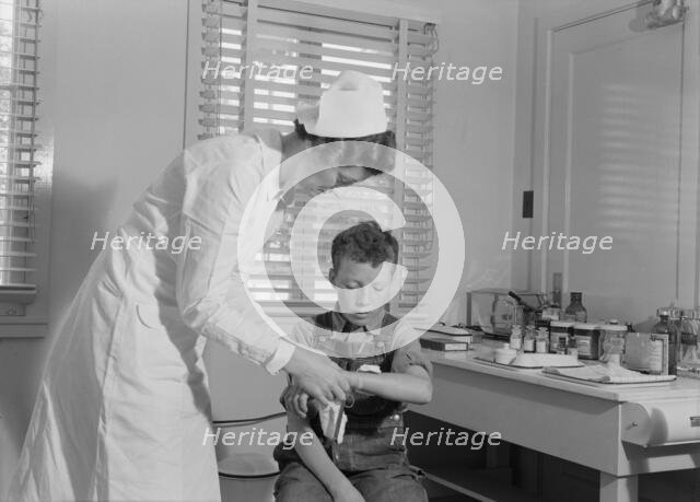 Migratory boys come to the clinic for attention, FSA camp at Farmersville, Tulare County, 1939. Creator: Dorothea Lange.