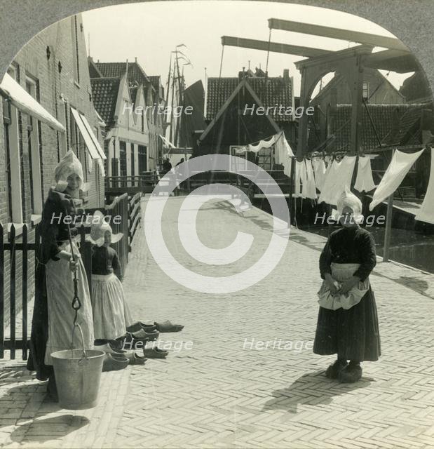 'Washday in Volendam, Netherlands - Shoes Large and Small and Some Who Wear Them', c1930s. Creator: Unknown.