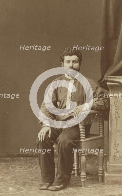 Full-length portrait of Armenian man, seated, facing front, between 1870 and 1886. Creator: Unknown.