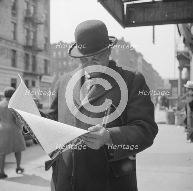 A Marcus Garveyite reading the OWI publication Negroes and the War, New York, 1943. Creator: Gordon Parks.
