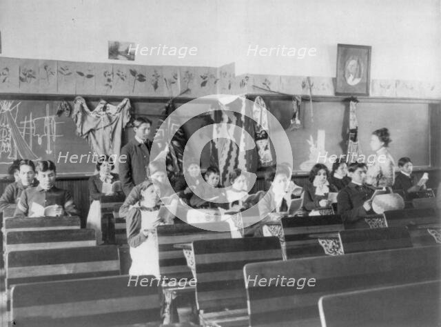 Male and female students reading in class, Carlisle Indian School, Carlisle, Pennsylvania, 1901. Creator: Frances Benjamin Johnston.