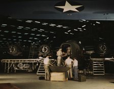Getting a nose door ready to put on a C-87...Consolidated Aircraft Corp..., Fort Worth, Texas, 1942. Creator: Howard Hollem.