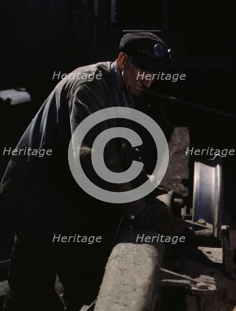 Sam Cell, working on the truck of a car..., C & NW RR's Proviso yard, Chicago, Ill., 1943. Creator: Jack Delano.