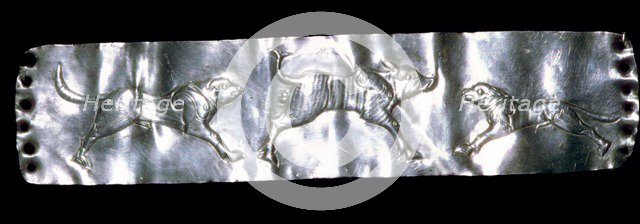 Parthian silver plaque of two dogs and a boar.