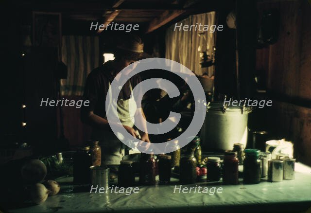 Wife of Jim Norris with canned goods, Pie Town, New Mexico, 1940. Creator: Russell Lee.