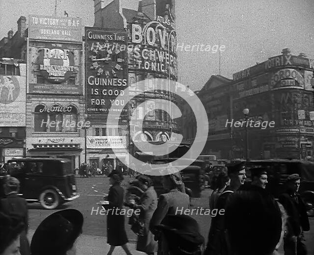 People and Traffic Moving Across Piccadilly Circus, 1943. Creator: British Pathe Ltd.