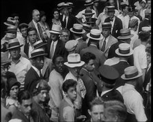 People Walking Around on a Crowded Street, 1930s. Creator: British Pathe Ltd.