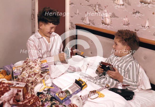Two boys opening presents at Christmas, c1955-1965. Creator: Arthur Charles Kirby Ware.