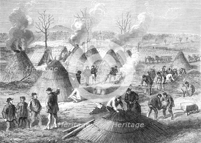 Making charcoal in the Bois de Boulogne, Paris, (sketch by balloon post), 1871. Creator: Unknown.