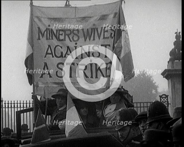 Women Gathering Around a Banner Reading 'Miners Wives Against a Strike', 1920. Creator: British Pathe Ltd.