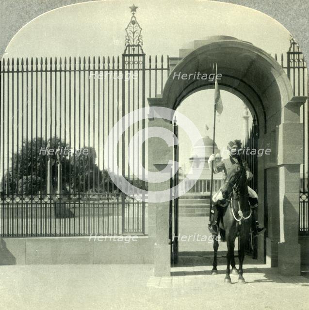 'Through a Sentry-guarded Gateway to the Beautiful Government Buildings of New Delhi', c1930s. Creator: Unknown.
