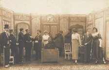 Prisoners of war, some in drag, posing on stage during a crowded scene of "Noblesse...(1910-1919?). Creator: Unknown.