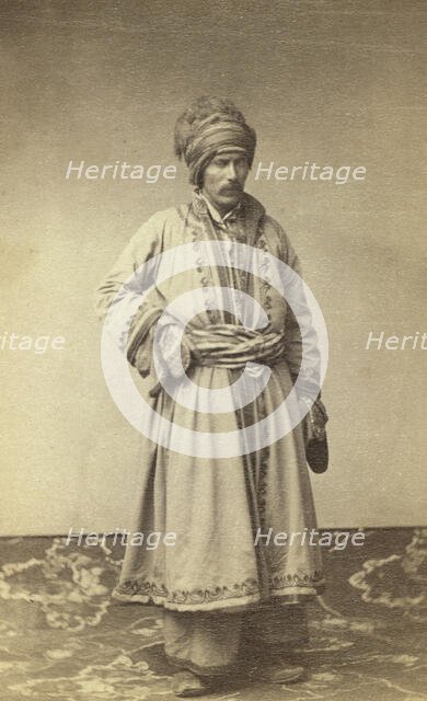 George Kennan, full-length portrait in traditional costume of unidentified..., between 1870 and 86. Creator: Unknown.