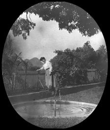 Woman by a pond in a garden, Rio de Janeiro, Brazil, late 19th or early 20th century. Artist: Unknown