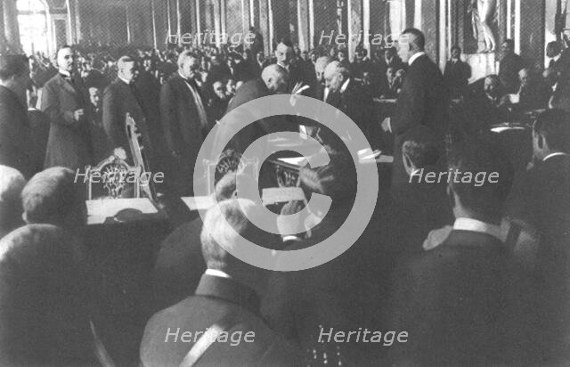 'La signature du traite de paix a Versailles; M Clemenceau signe debout: derriere..., 1919. Creator: Unknown.