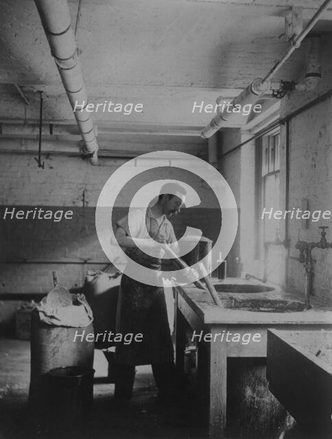 Worker prepares gum for postage stamps in the Stamp Division at the Bureau of Engraving..., c1895. Creator: Frances Benjamin Johnston.