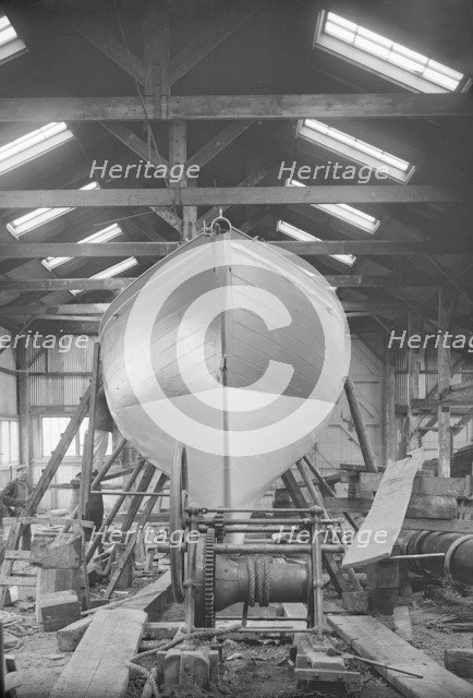 The yawl 'Banzai' in shed at boatyard, 1912. Creator: Kirk & Sons of Cowes.