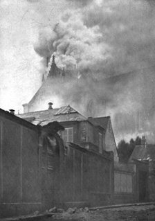 ''Le Cathedrale de Reims en flammes; Le clocher a l'Ange et la toiture du chevet en feu', 1914. Creator: T Holden Waterhouse.