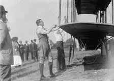 Claude Grahame-White - Fixing Wing of His Forman Plane, 1910. Creator: Harris & Ewing.