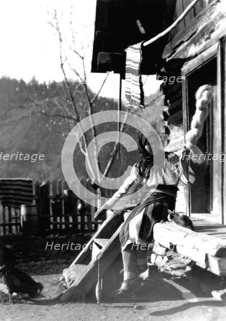 Woman spinning wool, Bistrita Valley, Moldavia, north-east Romania, c1920-c1945. Artist: Adolph Chevalier