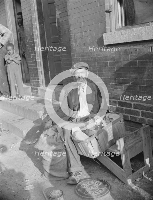 An old peanut vendor on Seaton Road, Washington, D.C., 1942. Creator: Gordon Parks.