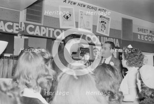 Portrait of Tommy Dorsey and William P. Gottlieb, record store, Washington, D.C., ca. 1940. Creator: Delia Potofsky Gottlieb.