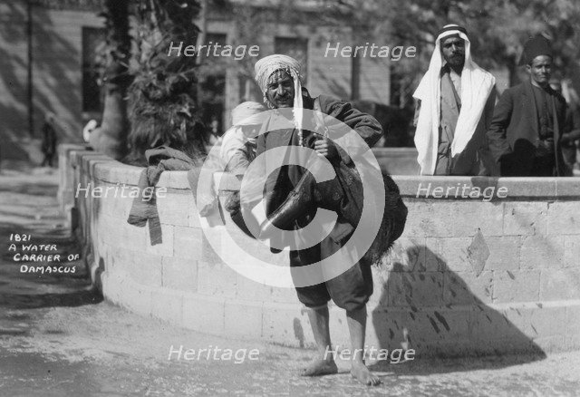 A water carrier in Damascus, Syria, c1920s-c1930s(?). Artist: Unknown