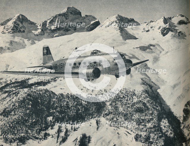 A Swissair plane flying near St Moritz Aerodrome, Switzerland, c1936 (c1937). Artist: Unknown.