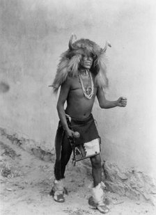 Sia buffalo dancer. Full-length, standing, facing right, c1926. Creator: Edward Sheriff Curtis.