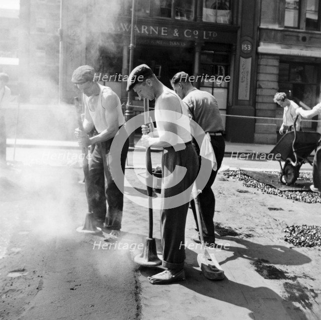 Workers repairing Queen Victoria Street, Westminster, London, 1955. Artist: Henry Grant
