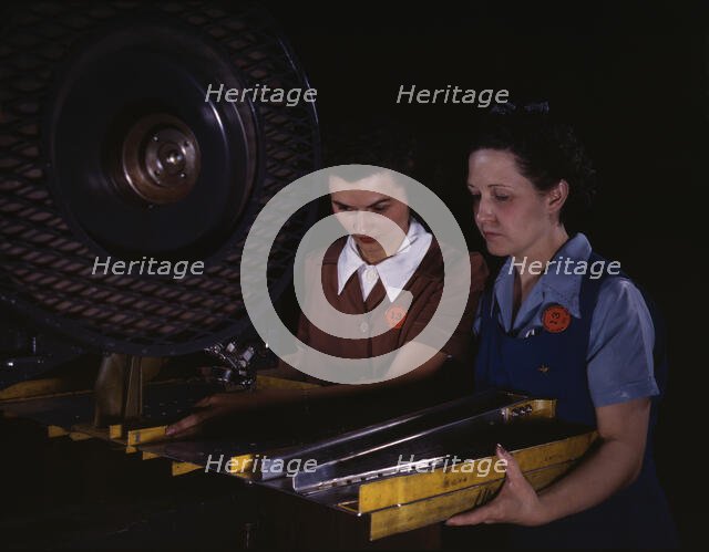 Punching rivet holes in a frame member for a B-25 bomber...North American Aviation, Inc., CA, 1942. Creator: Alfred T Palmer.