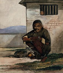 A man of Simla, squatting in a prison with manacles around his ankles, 1866. Creator: R Clint.