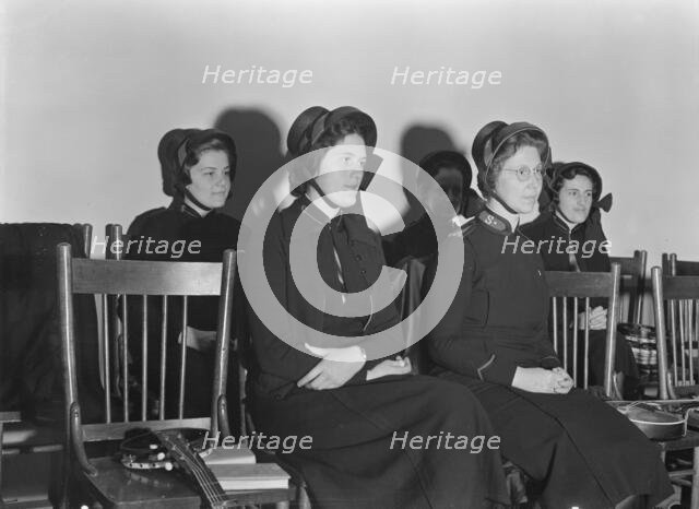 Visiting lassies sit on rostrom, Salvation Army, San Francisco, California, 1939. Creator: Dorothea Lange.
