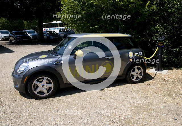 Electric Mini at battery charging point 2011 Artist: Unknown.