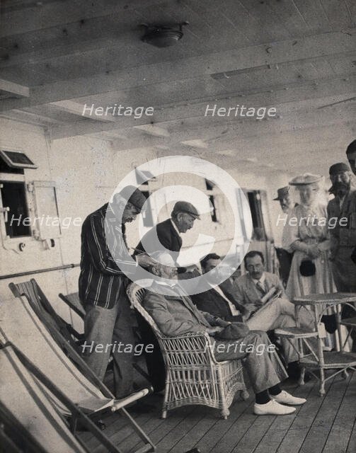 Members of the British Association playing at phrenology on board a ship on its way to..., 1905. Creator: James Thomson Bottomley.