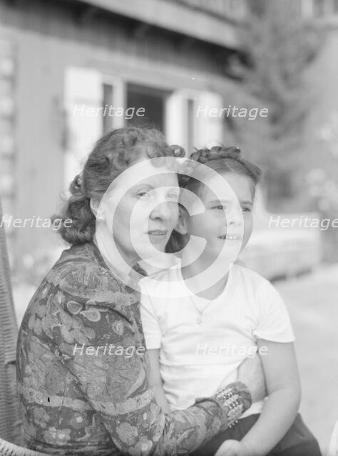 Churchill, Mrs., with child Orrin, seated outdoors, not before 1932 Mar. Creator: Arnold Genthe.