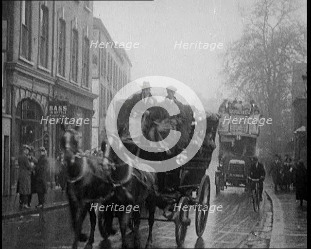 Vehicles Passing Along a Busy British Street, 1921. Creator: British Pathe Ltd.