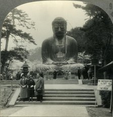 'The Colossal Daibutsu in Cherry-Blossom Time - the Great Bronze Buddha of Kamakura, Japan', c1930s. Creator: Unknown.