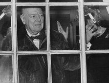 Sir Winston Churchill waving from his Hyde Park Gate window on his 89th birthday, 1963. Artist: Unknown