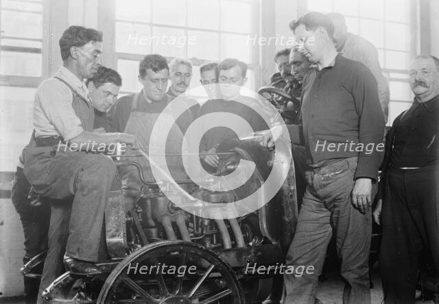 Firemen studying auto motor, between c1910 and c1915. Creator: Bain News Service.